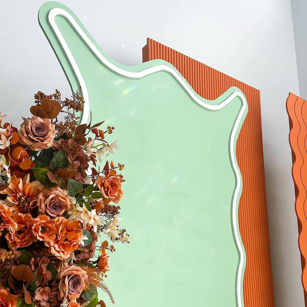 terracotta flower arrangement stuck on green wavy board with white outline