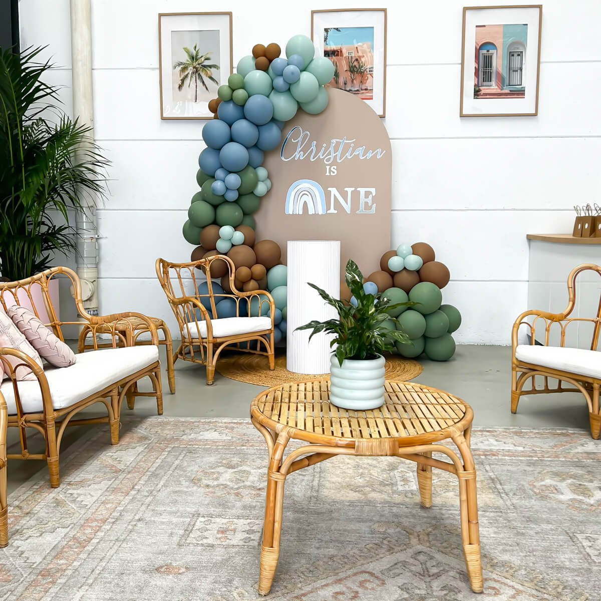 colourful arch backdrop event hire package with balloons at modern event space with bamboo furniture