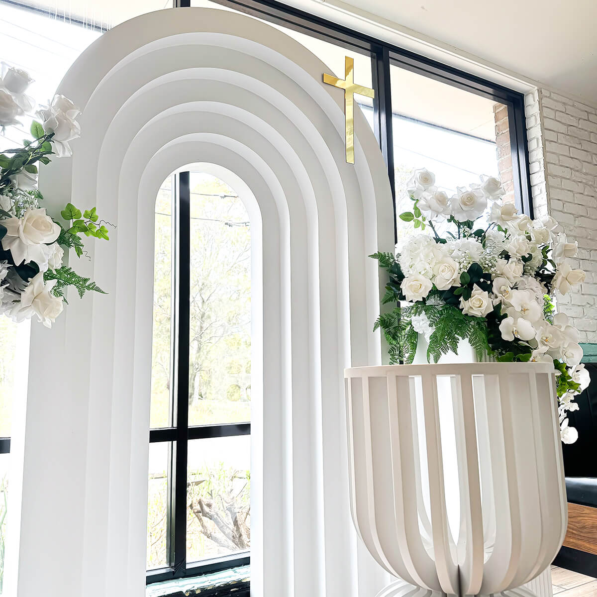 White 3D arch backdrop with gold cross displayed on corner