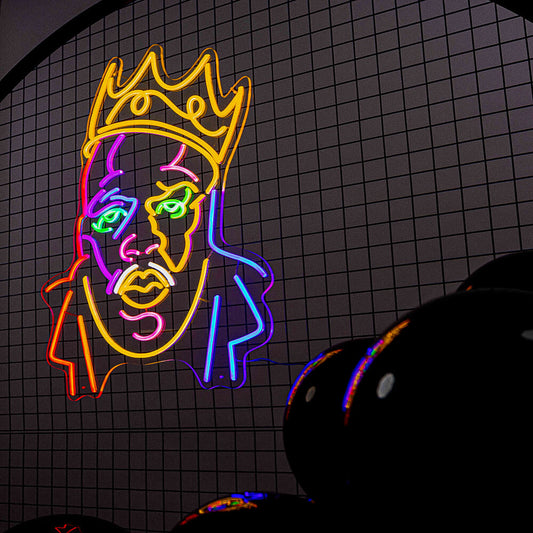 multicoloured biggie neon sign hanging on black mesh backdrop frame