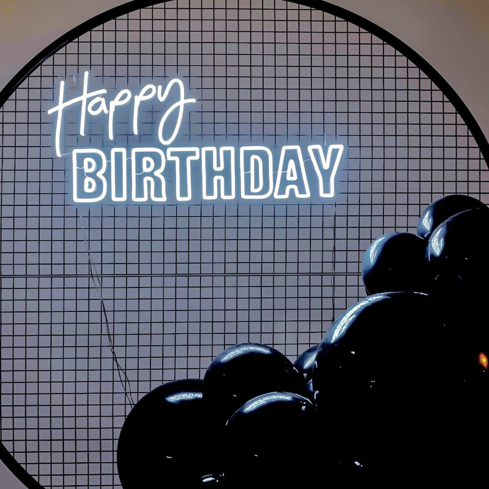 white happy birthday neon sign on black mesh backdrop frame